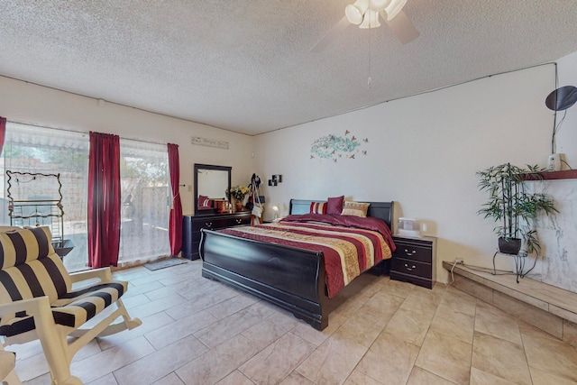 bedroom featuring ceiling fan, access to exterior, and a textured ceiling