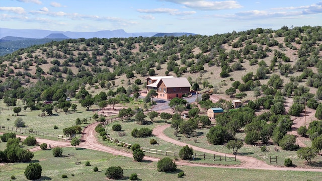 drone / aerial view featuring a mountain view and a rural view