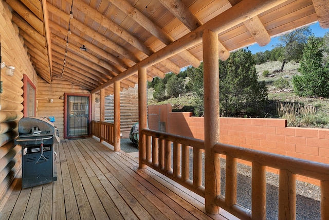 wooden deck featuring a grill