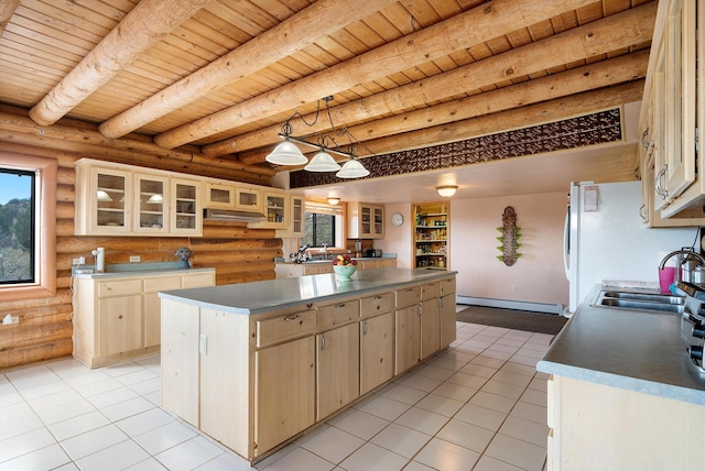 kitchen with a kitchen island, a baseboard radiator, light brown cabinetry, beam ceiling, and sink