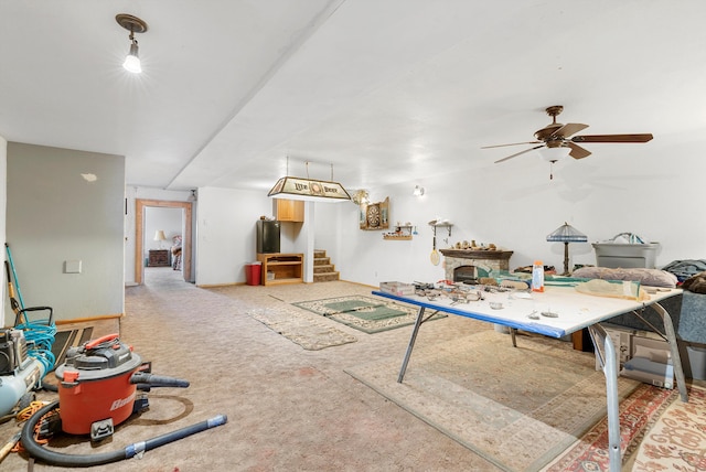 recreation room with ceiling fan and carpet