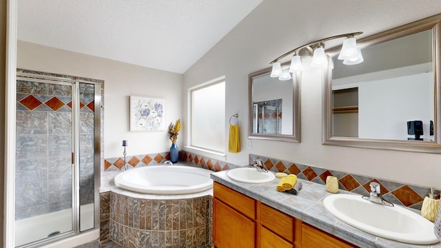 bathroom with vanity, separate shower and tub, and lofted ceiling