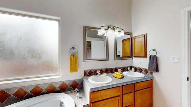 bathroom featuring vanity and a tub to relax in