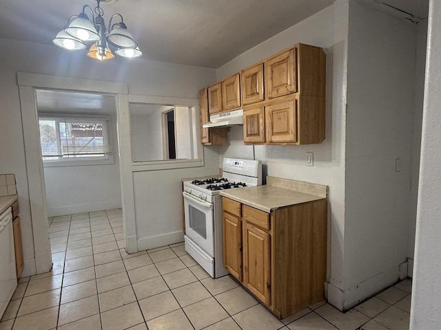 kitchen featuring white appliances, decorative light fixtures, a notable chandelier, and light tile patterned floors