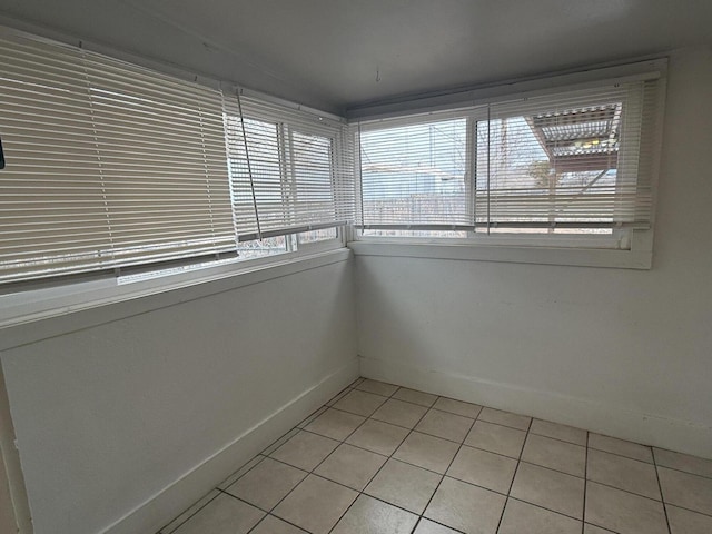 tiled empty room featuring plenty of natural light