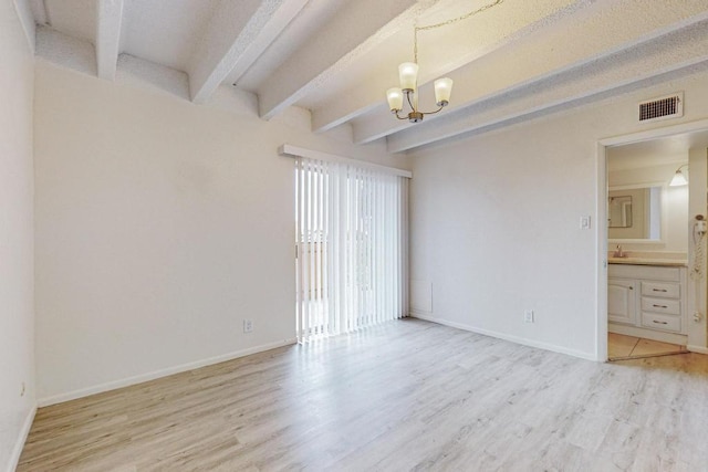 unfurnished room featuring an inviting chandelier, sink, beam ceiling, and light hardwood / wood-style floors