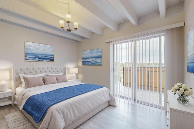 bedroom with an inviting chandelier, access to exterior, light hardwood / wood-style floors, and beam ceiling