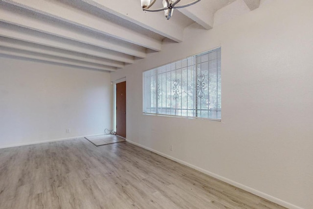 unfurnished room with beamed ceiling, wood-type flooring, and a chandelier