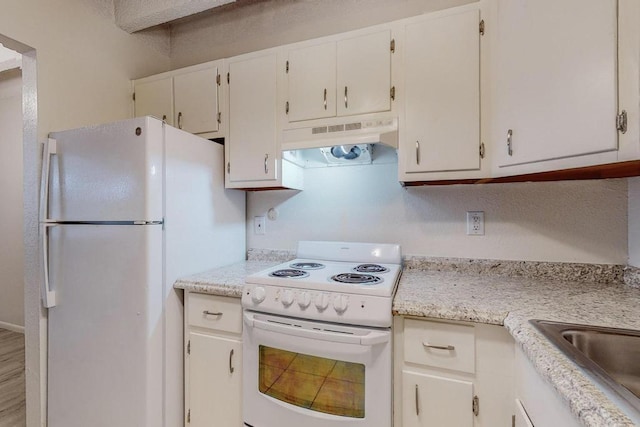 kitchen featuring sink, white appliances, and white cabinets