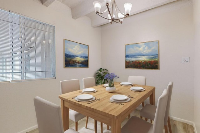 dining room featuring beamed ceiling and a chandelier