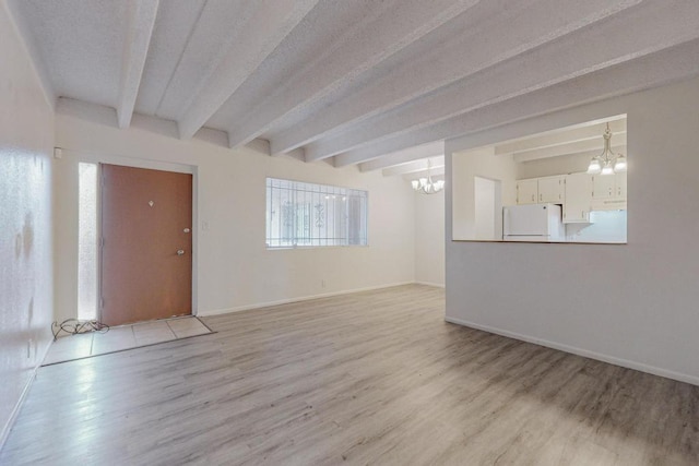 interior space with beam ceiling, a chandelier, and light hardwood / wood-style flooring