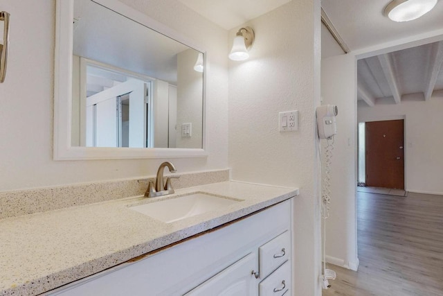 bathroom with vanity and wood-type flooring