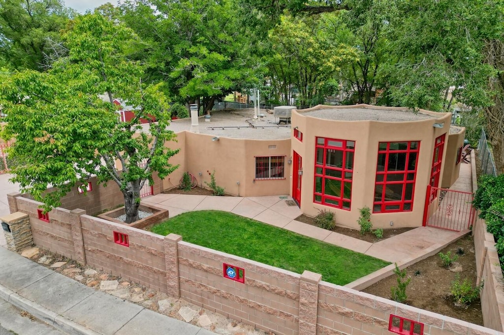 pueblo-style house featuring central air condition unit