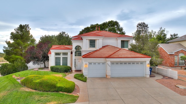 mediterranean / spanish-style house with a front yard and a garage