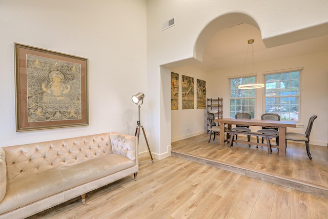 dining room featuring wood finished floors, visible vents, and baseboards