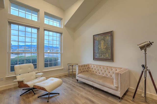 living area with wood finished floors and baseboards