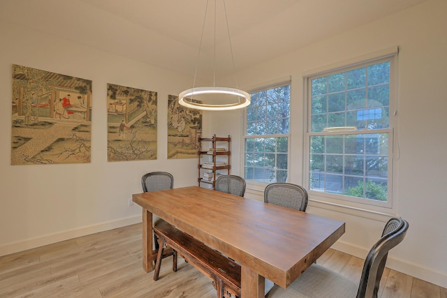 dining room with light wood-style flooring and baseboards