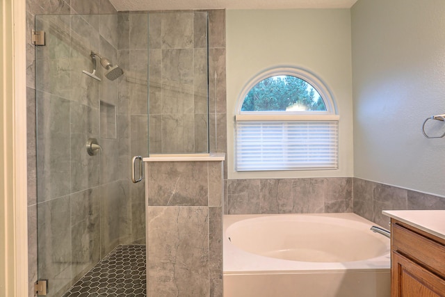 full bath with a garden tub, a shower stall, and vanity