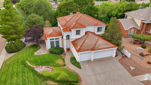 view of front of house featuring driveway, a tile roof, and stucco siding