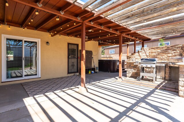 view of patio / terrace featuring exterior kitchen and a grill