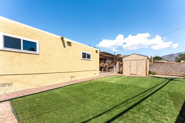 view of yard featuring a shed and a mountain view