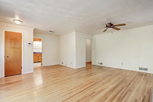 spare room featuring light hardwood / wood-style floors and ceiling fan