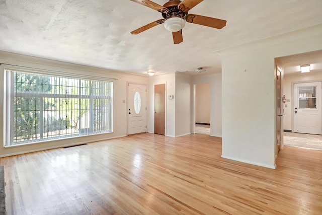 unfurnished living room with ceiling fan and light hardwood / wood-style flooring