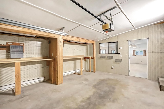 garage featuring a workshop area, a garage door opener, and a baseboard radiator