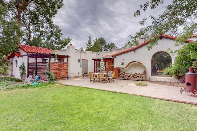 back of house featuring a yard and a patio area