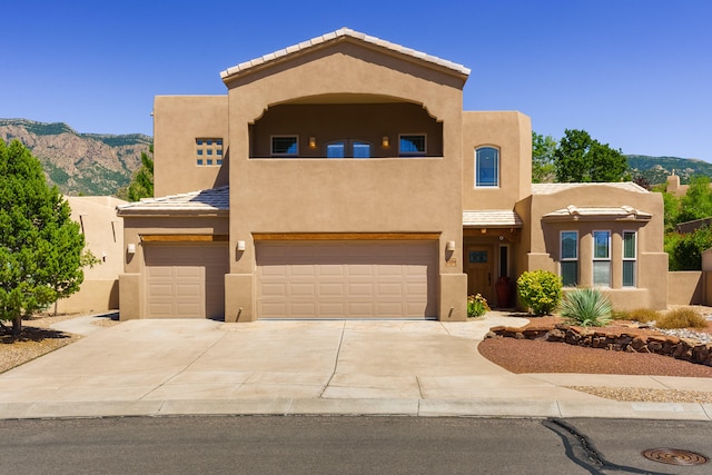 southwest-style home featuring a mountain view and a garage