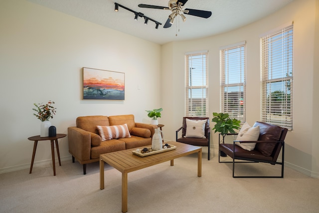 living room with a textured ceiling, ceiling fan, light carpet, and track lighting