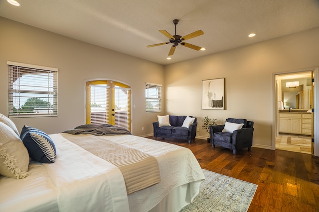 bedroom featuring ensuite bathroom, french doors, dark hardwood / wood-style floors, access to outside, and ceiling fan