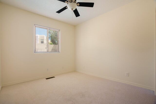 empty room with ceiling fan and carpet floors