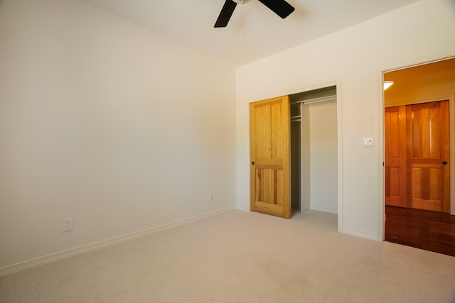 unfurnished bedroom with a closet, ceiling fan, and light carpet