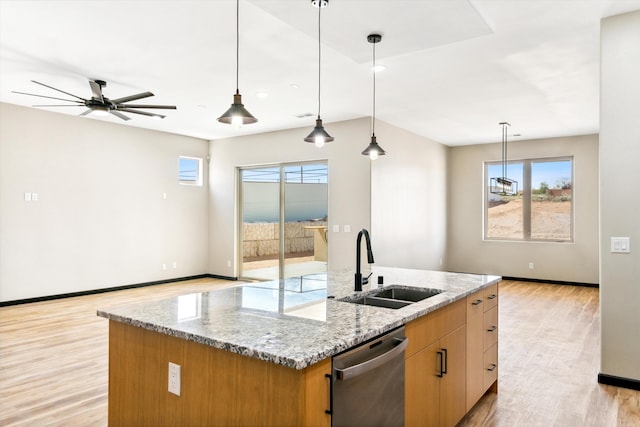 kitchen featuring ceiling fan, dishwasher, plenty of natural light, and a center island with sink