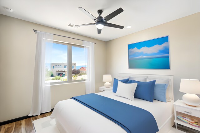 bedroom with ceiling fan and wood-type flooring