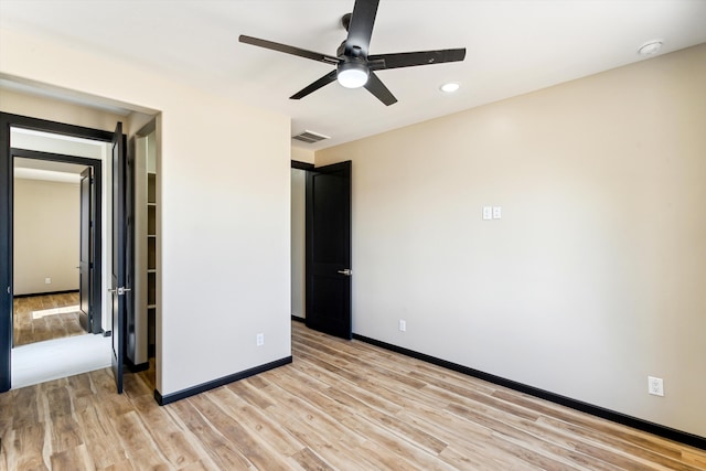 unfurnished bedroom with ceiling fan and light hardwood / wood-style floors