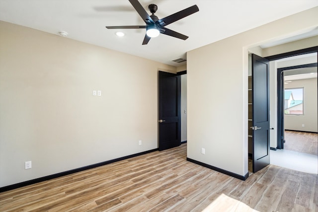 unfurnished bedroom with ceiling fan and light hardwood / wood-style flooring