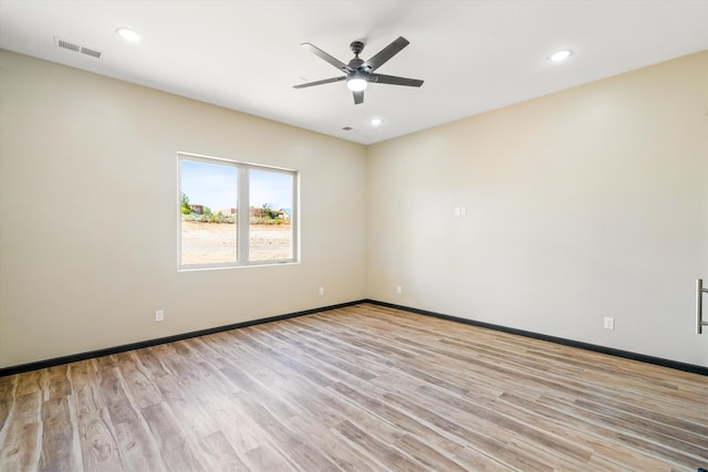 empty room with light wood-type flooring and ceiling fan