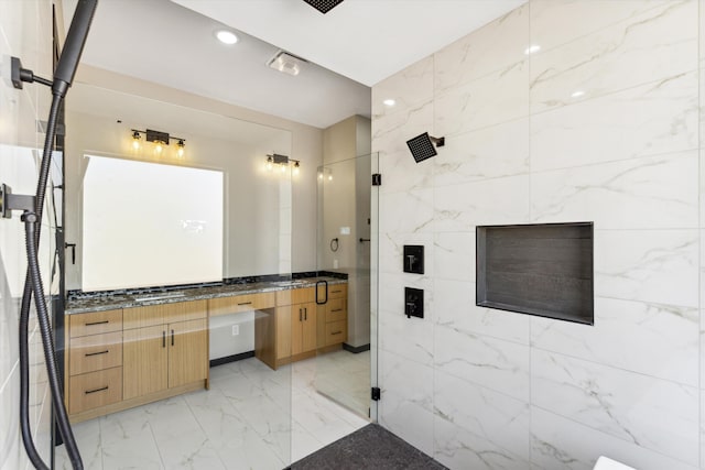 bathroom featuring vanity, tile walls, and walk in shower