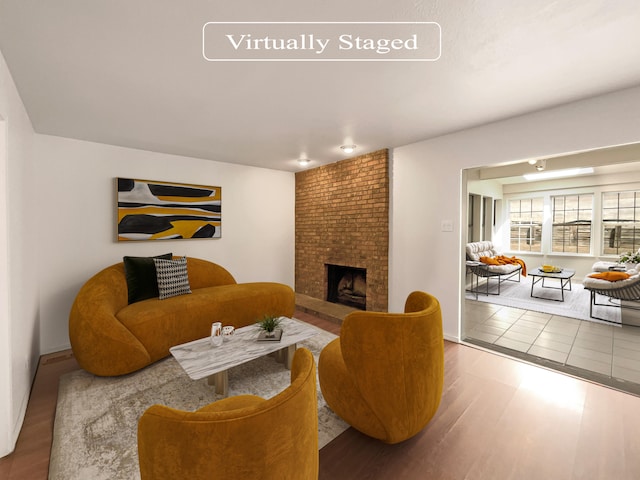 living room with hardwood / wood-style floors and a brick fireplace