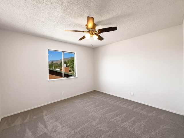 carpeted spare room with ceiling fan and a textured ceiling