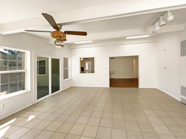 unfurnished room with track lighting, light tile patterned floors, beam ceiling, and ceiling fan