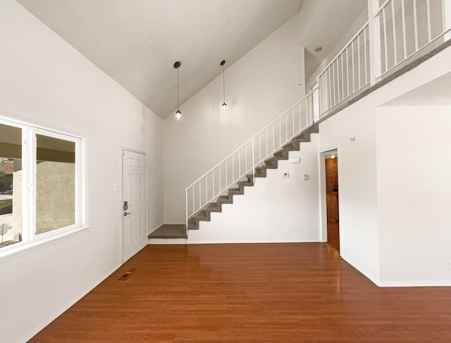 foyer entrance featuring high vaulted ceiling and hardwood / wood-style flooring