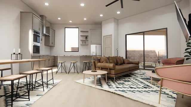 living room with ceiling fan and light hardwood / wood-style floors