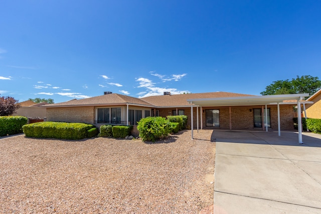 ranch-style home featuring a carport