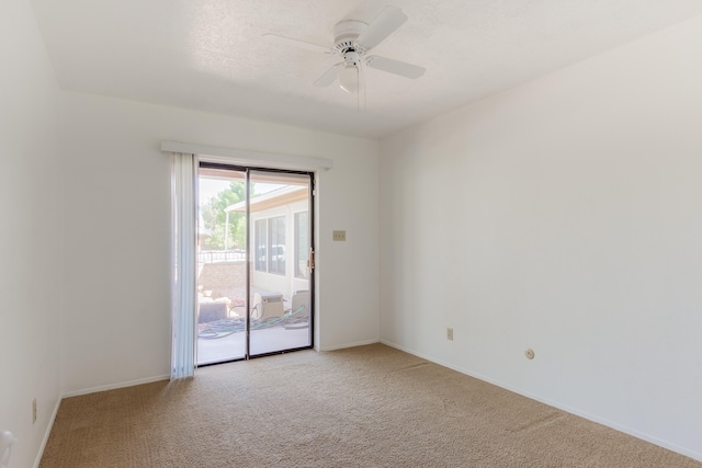 spare room with ceiling fan and light colored carpet