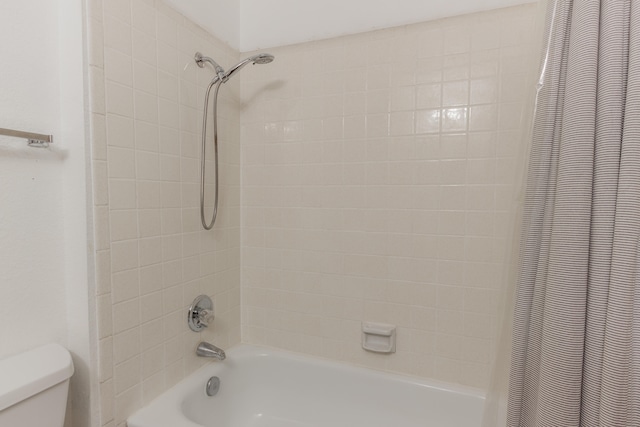 bathroom with shower / tub combo and toilet