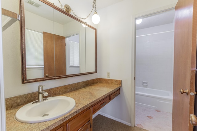 bathroom with shower / bathing tub combination, tile patterned floors, and vanity