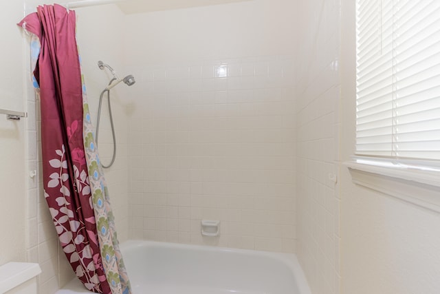 bathroom with shower / bath combination with curtain